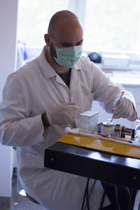 Doctor working at table in laboratory