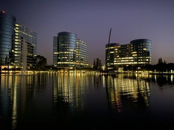 Reflection of illuminated buildings in city at night