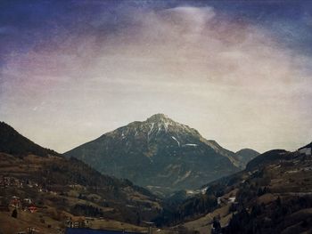 Scenic view of mountains against dramatic sky