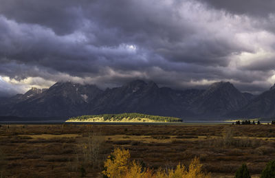 Scenic view of mountains against cloudy sky