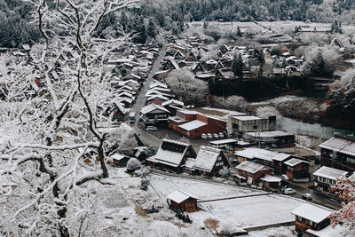 High angle view of trees and buildings in city during winter