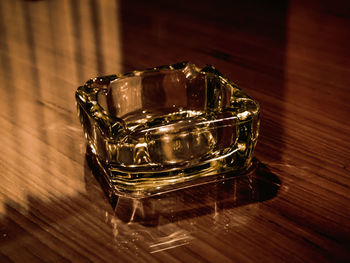 High angle view of glass ashtray on table