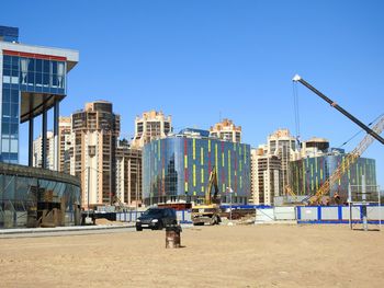 Buildings against clear blue sky