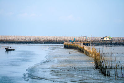 Scenic view of lake against sky during winter