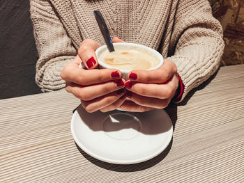 Midsection of woman holding ice cream