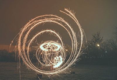 Light painting on field against sky at night