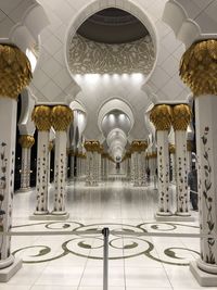 Illuminated chandelier hanging in building