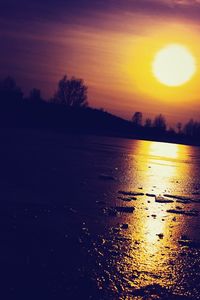 Scenic view of lake at sunset