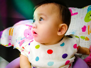 Close-up of cute baby boy on bed