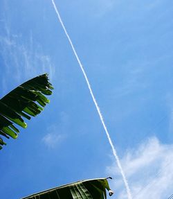 Low angle view of vapor trail against blue sky