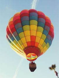 Low angle view of person in hot air balloon flying against sky