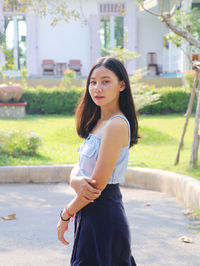 Portrait of beautiful young woman standing outdoors