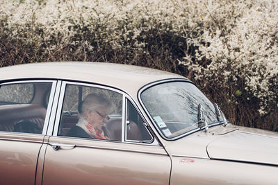 Reflection of man on car window