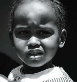 Close-up portrait of boy in sunny day