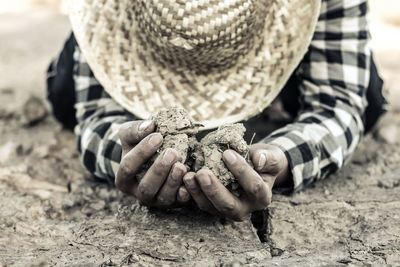 Woman kneeling on barren field