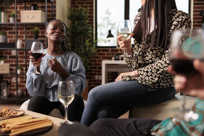 Portrait of young woman using mobile phone at restaurant