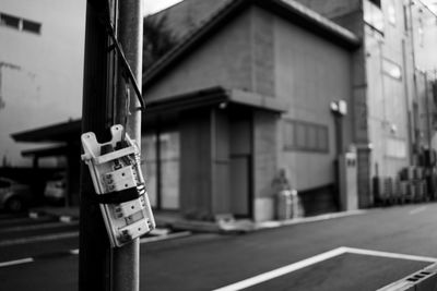 Close-up of information sign on street against building