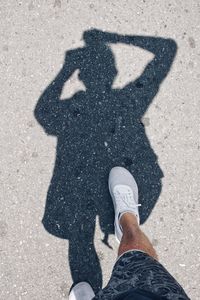 Low section of man standing on road