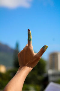 Close-up of woman hand against clear sky