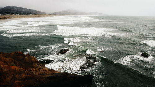 Scenic view of sea with mountain range in background