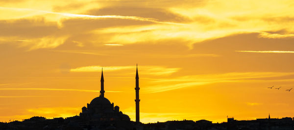 Evening atmosphere with dramatic sky over the dome and minarets of a mosque.