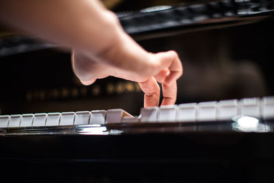 Midsection of person playing piano