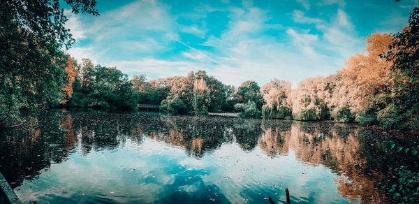 Reflection of trees in lake against sky