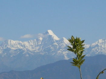 Scenic view of snowcapped mountains against clear sky