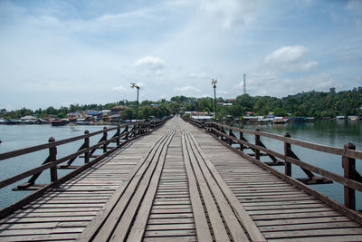 Pier over river against sky