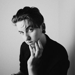 Portrait of young man against white background