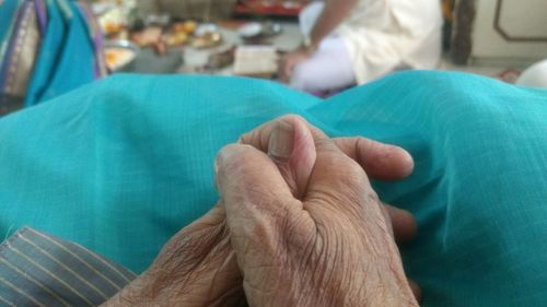 Cropped image of senior woman joining hands