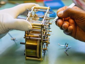 Close-up of person working on metal