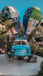 Vintage car against blue sky in city