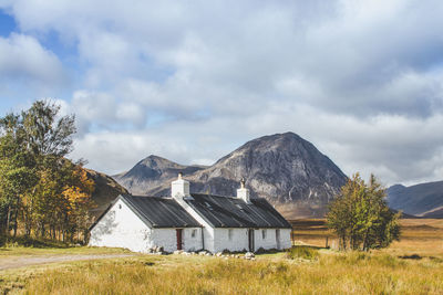 Scenic view of landscape and houses against sky