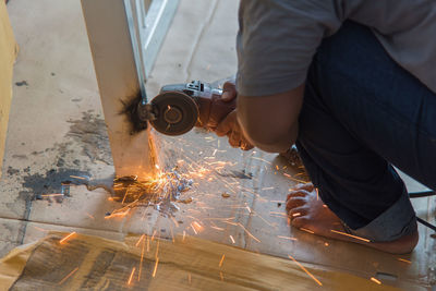 Close-up of person working on metal