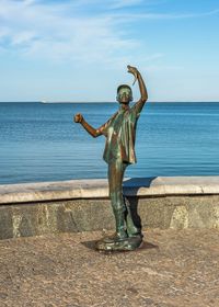 Full length of man standing by sea against sky