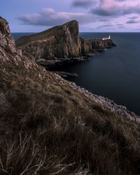 Scenic view of lighthouse on rocks against sky