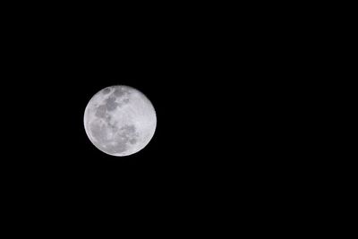 Low angle view of moon against clear sky at night