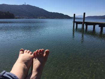 Low section of person relaxing in lake