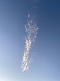 Low angle view of vapor trail against blue sky