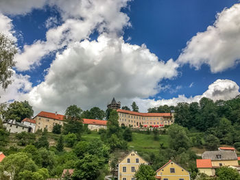 Buildings in town against sky