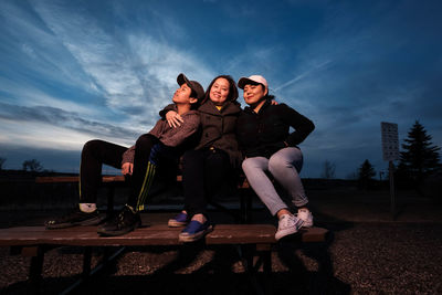 Young couple sitting outdoors