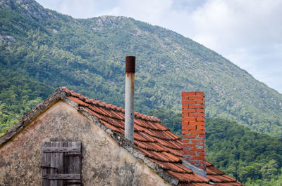 Built structure on mountain against sky