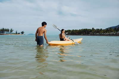 Man surfing in sea against sky