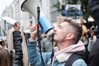 Group of people holding camera in city