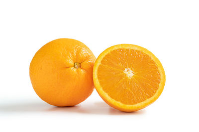 Close-up of orange fruit against white background