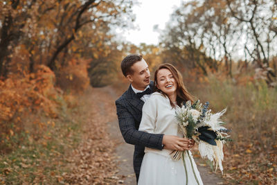 Portrait of smiling woman holding bouquet