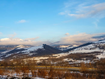 Aerial view of snowcapped mountains against sky