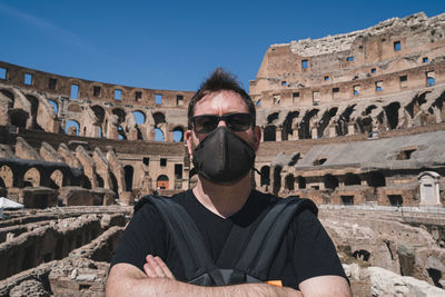 Full length portrait of man against historic building