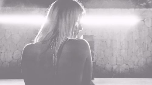 Rear view of woman looking at camera